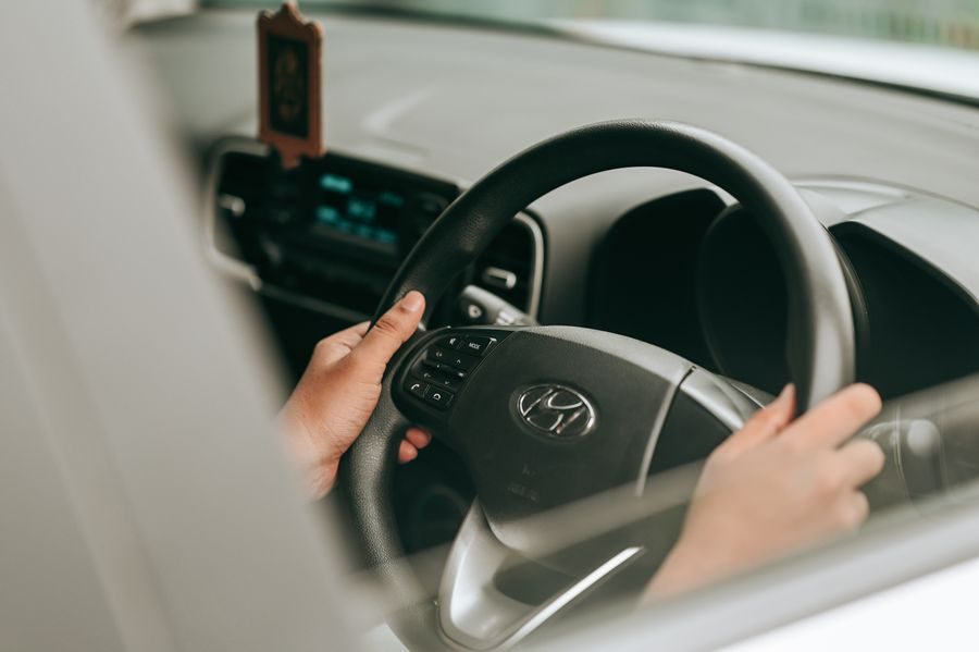 Hands on a steering wheel, driving