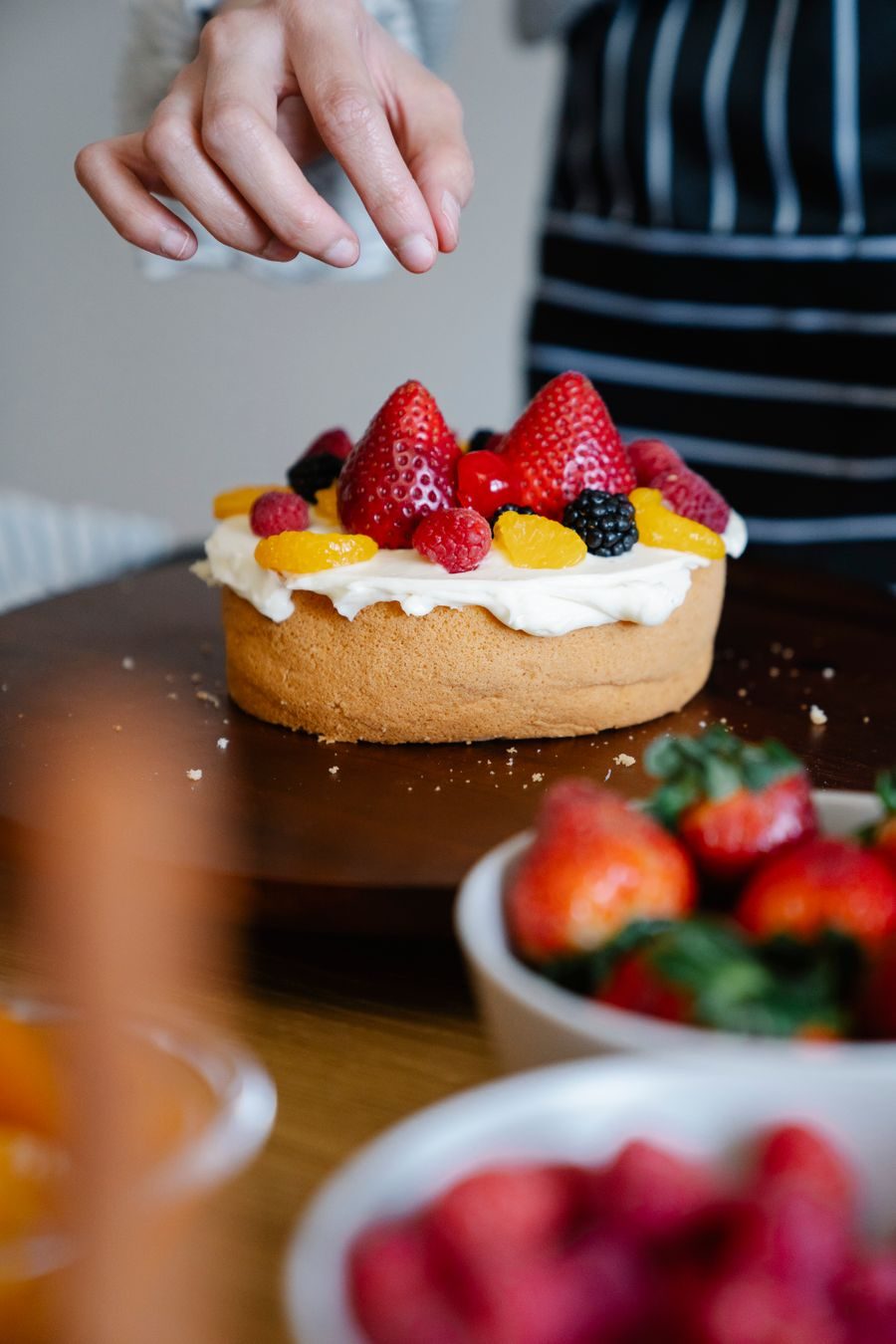 Decorating a berry tart in a warm kitchen